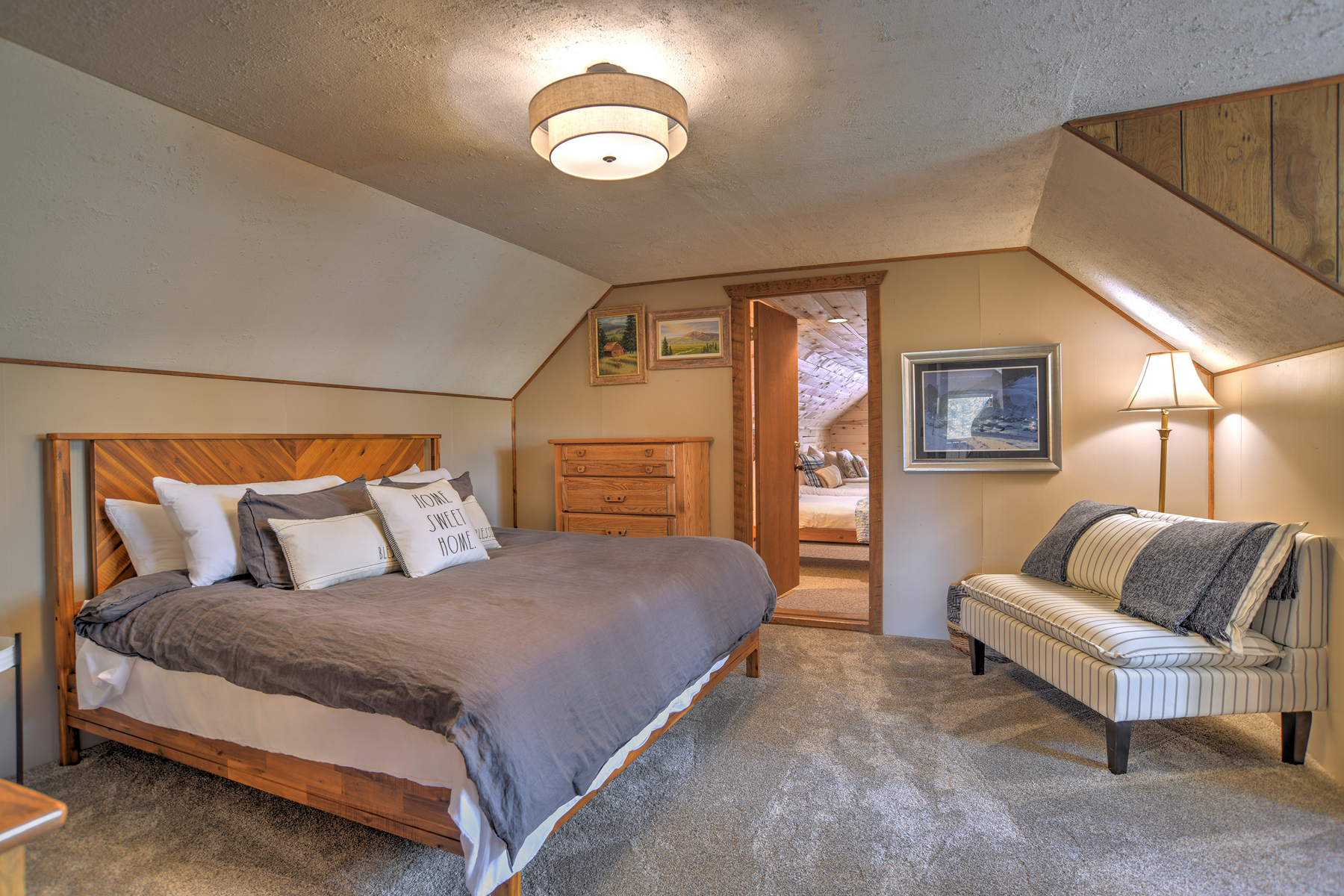Second-story king bedroom. Remote workspace and access to the twin bedroom through here. 