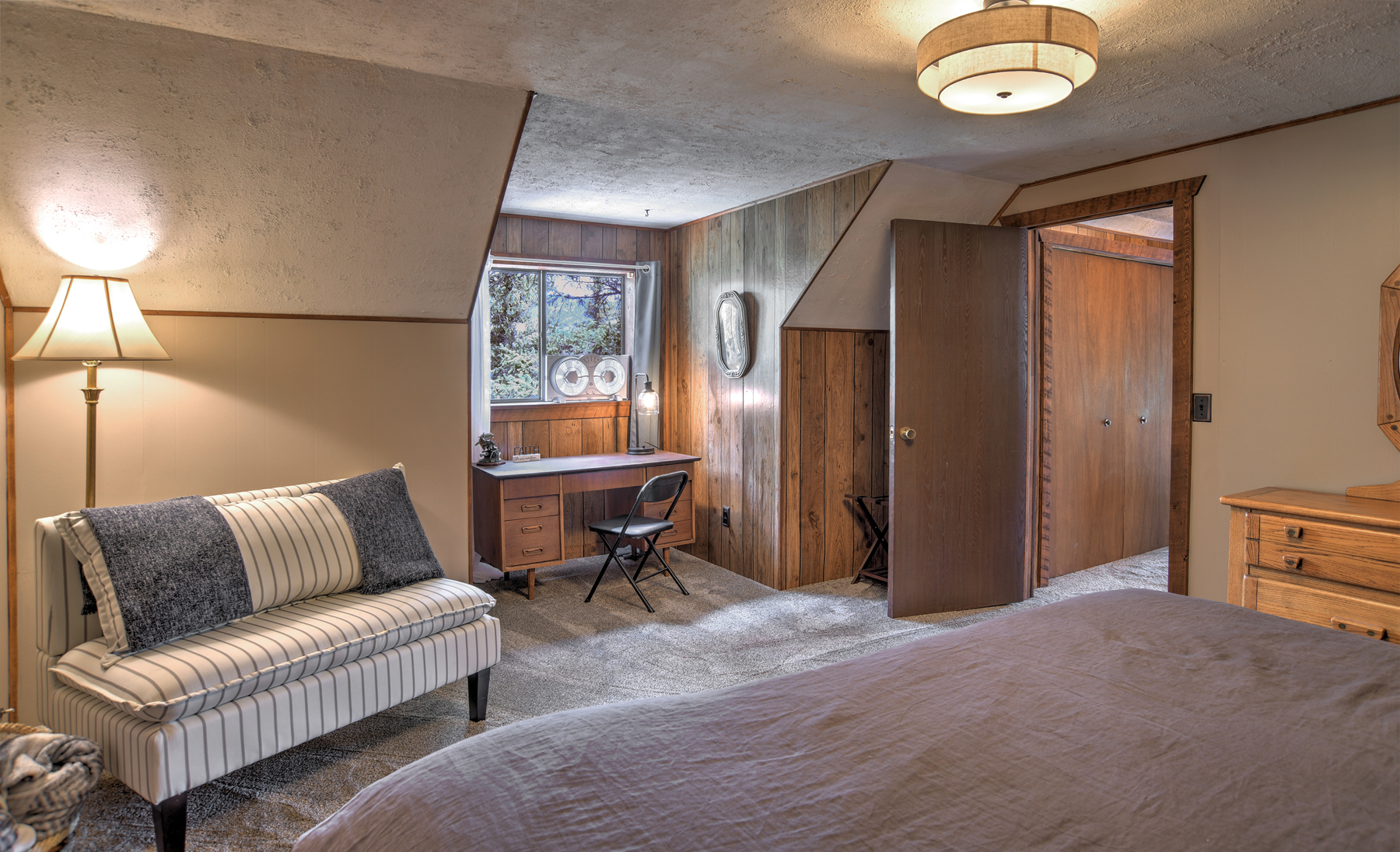 Second-story king bedroom with remote workspace and a twin bedroom accessible from this bedroom. 