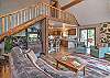 Living room with lots of windows perfect for enjoying the mountain and river views. 