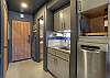Small kitchen area with full-sized fridge, stove, oven and dish washer. 