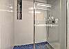 Full bathroom featuring a sleek walk-in shower.