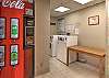 Vending machine and washing machine in the lodge. 