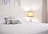 The guest bedroom features a king bed and Smart TV. 