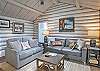 Living room that opens into the kitchen with a Smart TV.