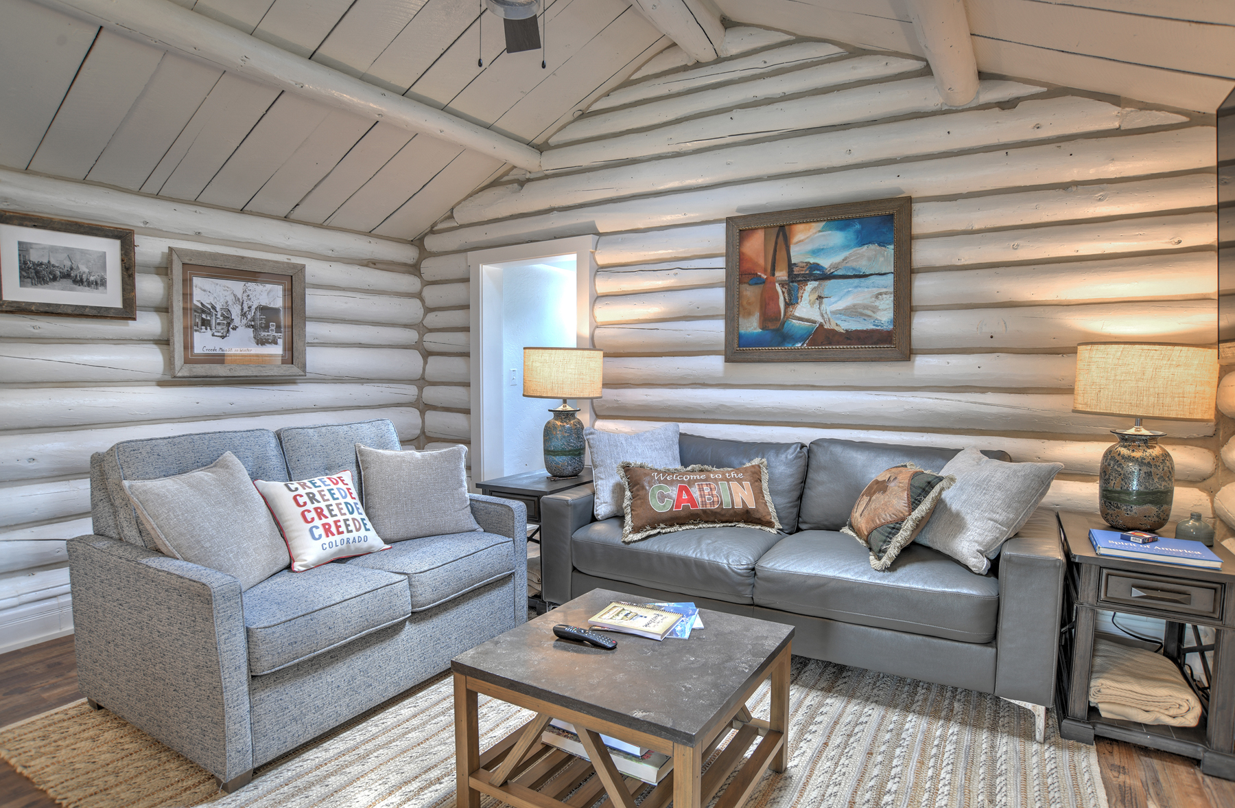 Living room that opens into the kitchen with a Smart TV.