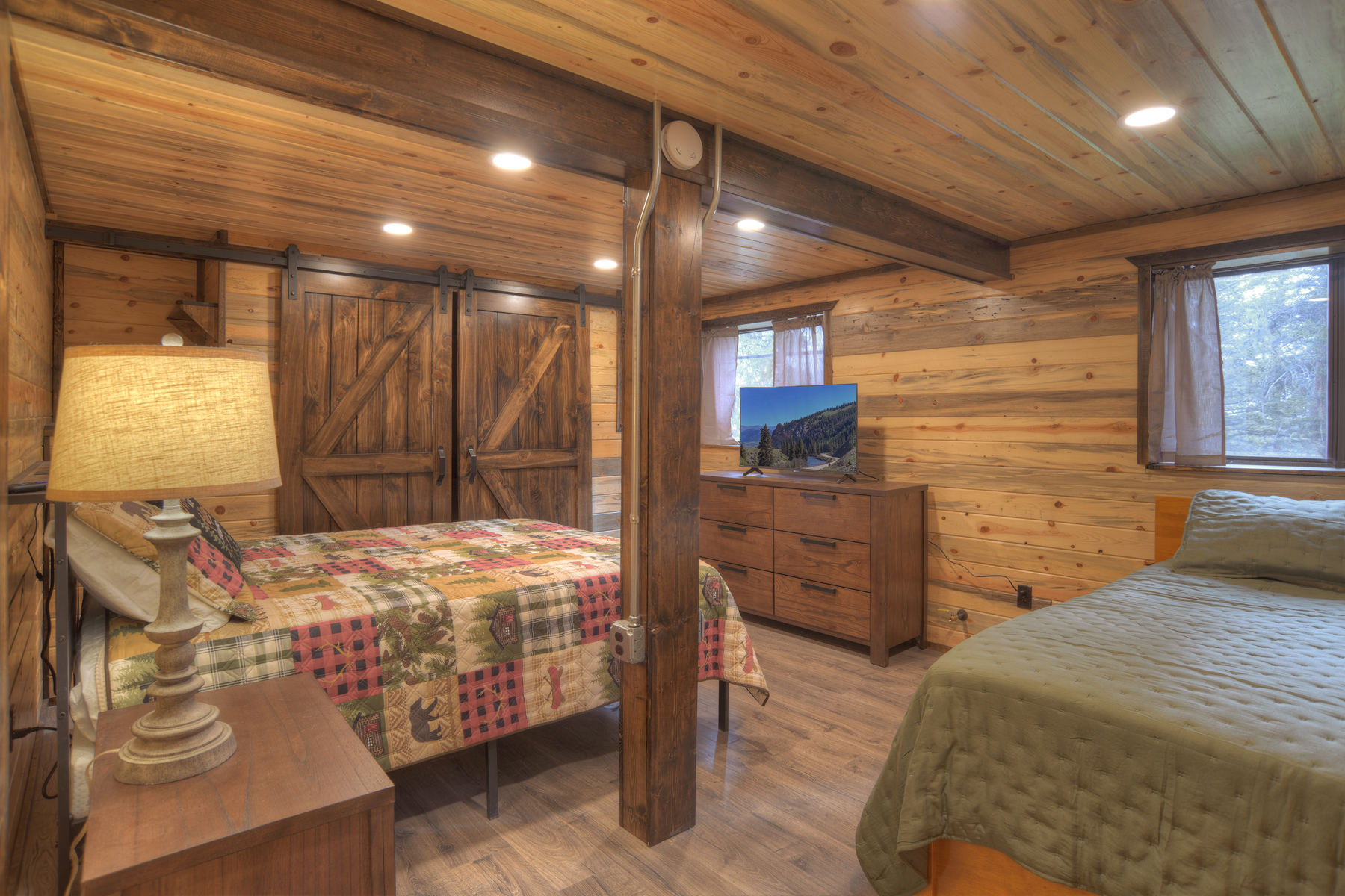 Our lower-level queen bedroom is equipped with a smart TV, and the bathroom is in the hall. 