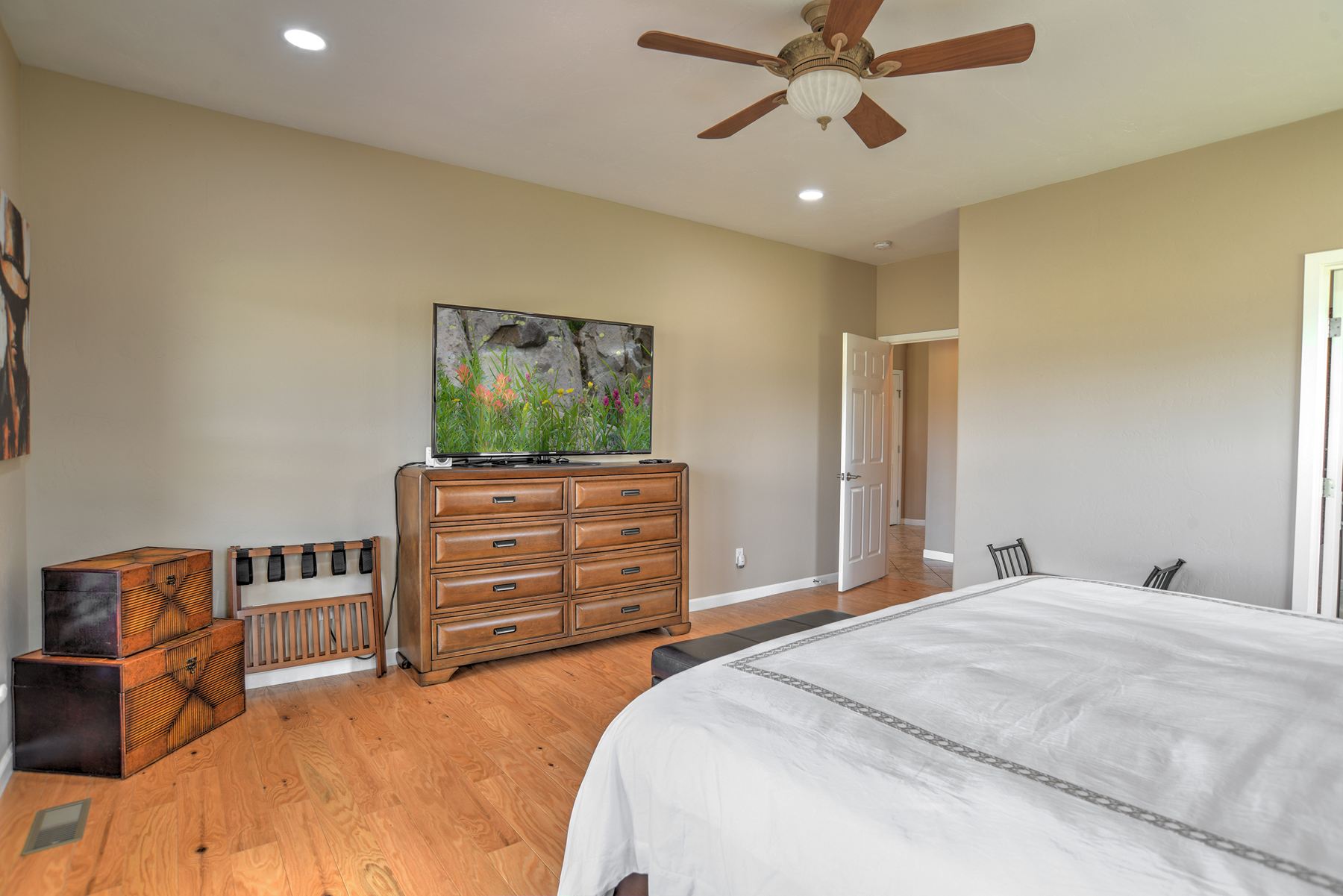 Main-level king bedroom with a king bed, a smart TV, and an ensuite bathroom. 