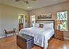 Main-level king bedroom with a king bed, a smart TV, and an ensuite bathroom. 