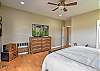 Main-level king bedroom with a king bed, a smart TV, and an ensuite bathroom. 