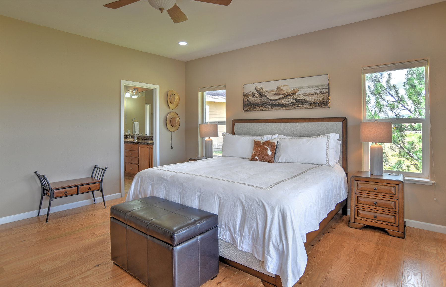 Main-level king bedroom with a king bed, a smart TV, and an ensuite bathroom. 