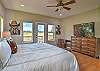 Main-level king bedroom with a king bed, a smart TV, and an ensuite bathroom. 