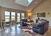 Open living room with lots of natural light, mountain and golf course views.  With a gas fireplace and comfortable seating. 