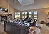 Our open living room offers a gas fireplace, mountain and golf course views, and access to our expansive back deck. 
