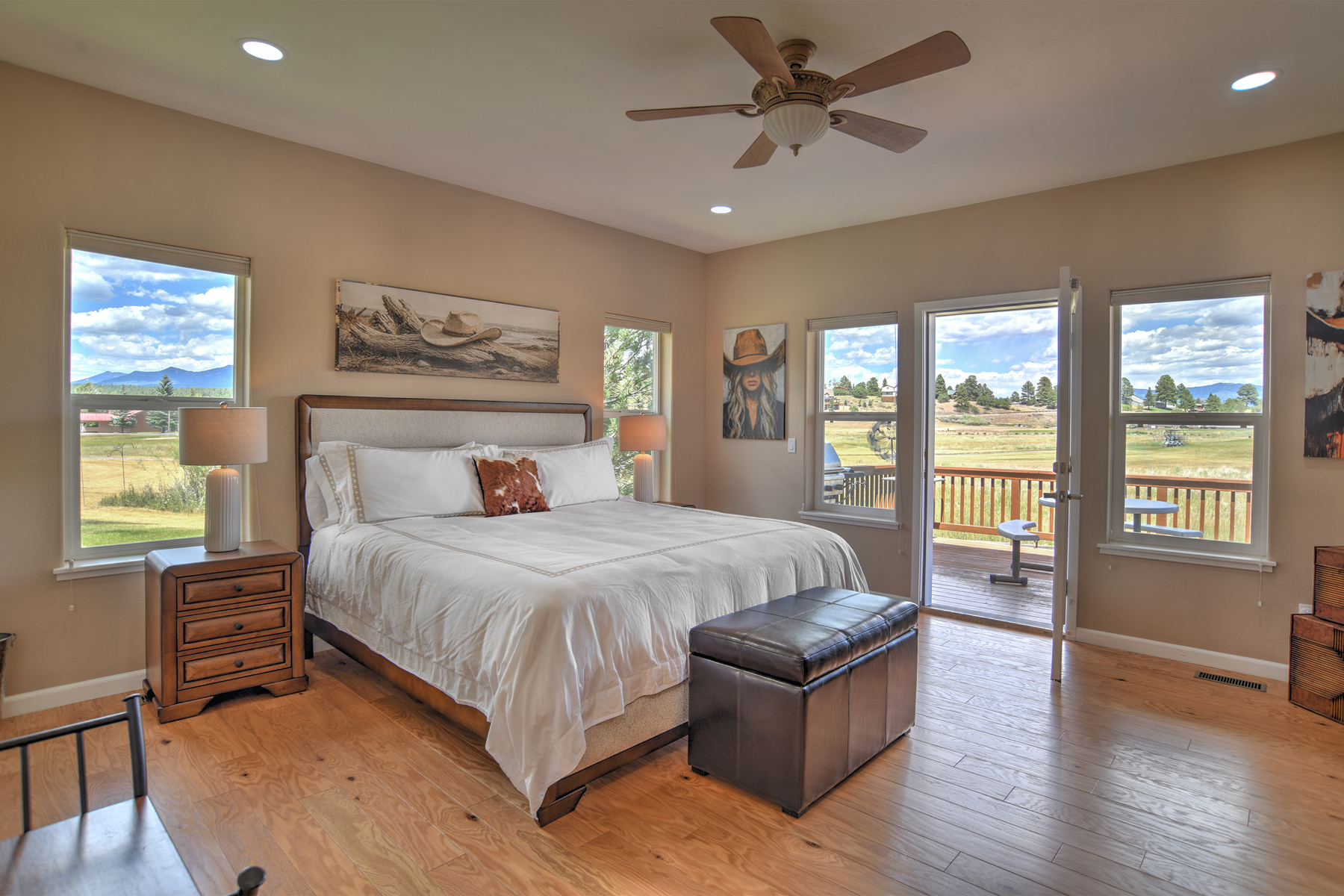 Main-level king bedroom with a king bed, a smart TV, and an ensuite bathroom. 