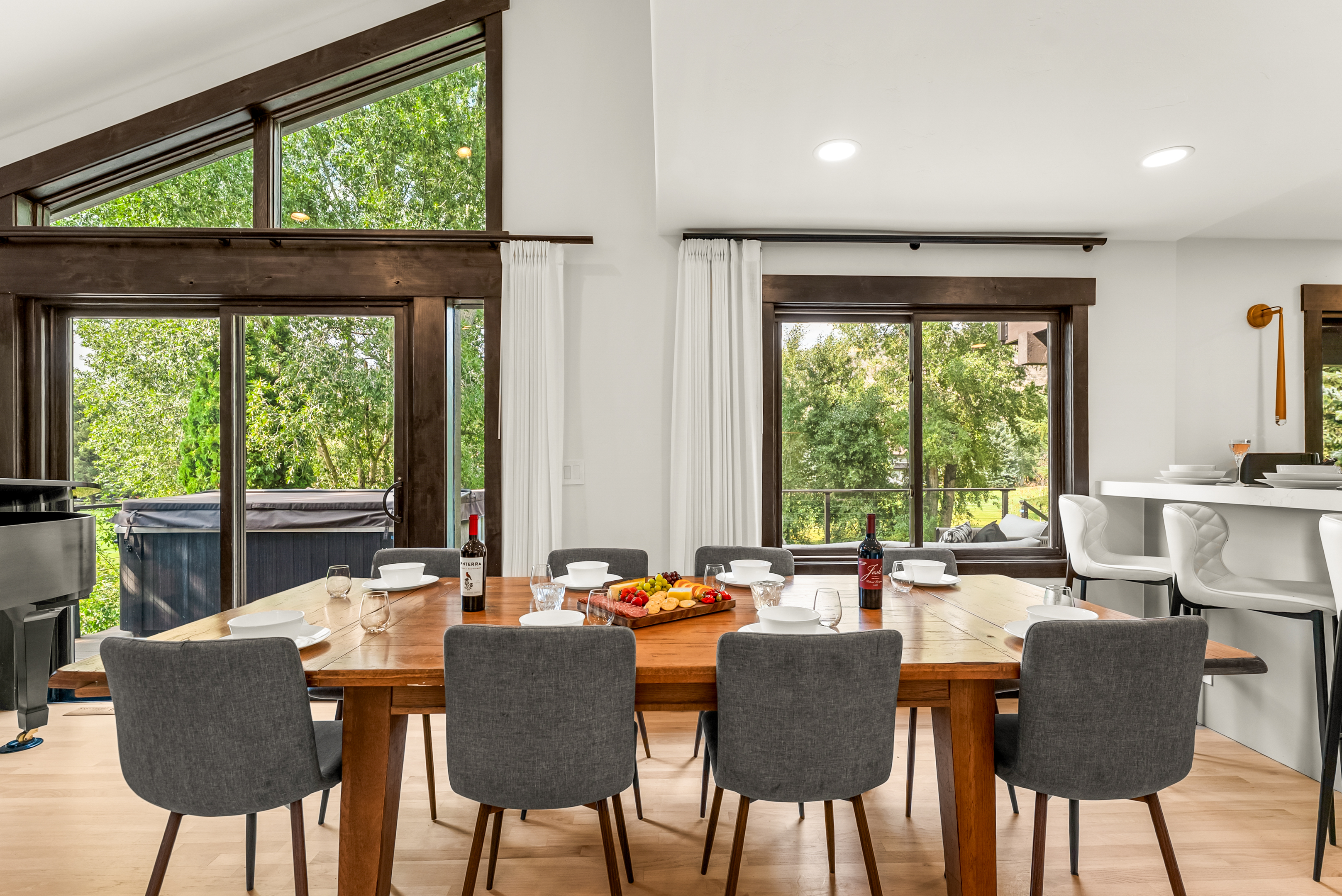 Main floor dining area: 10-seat dining table, 3 barstools