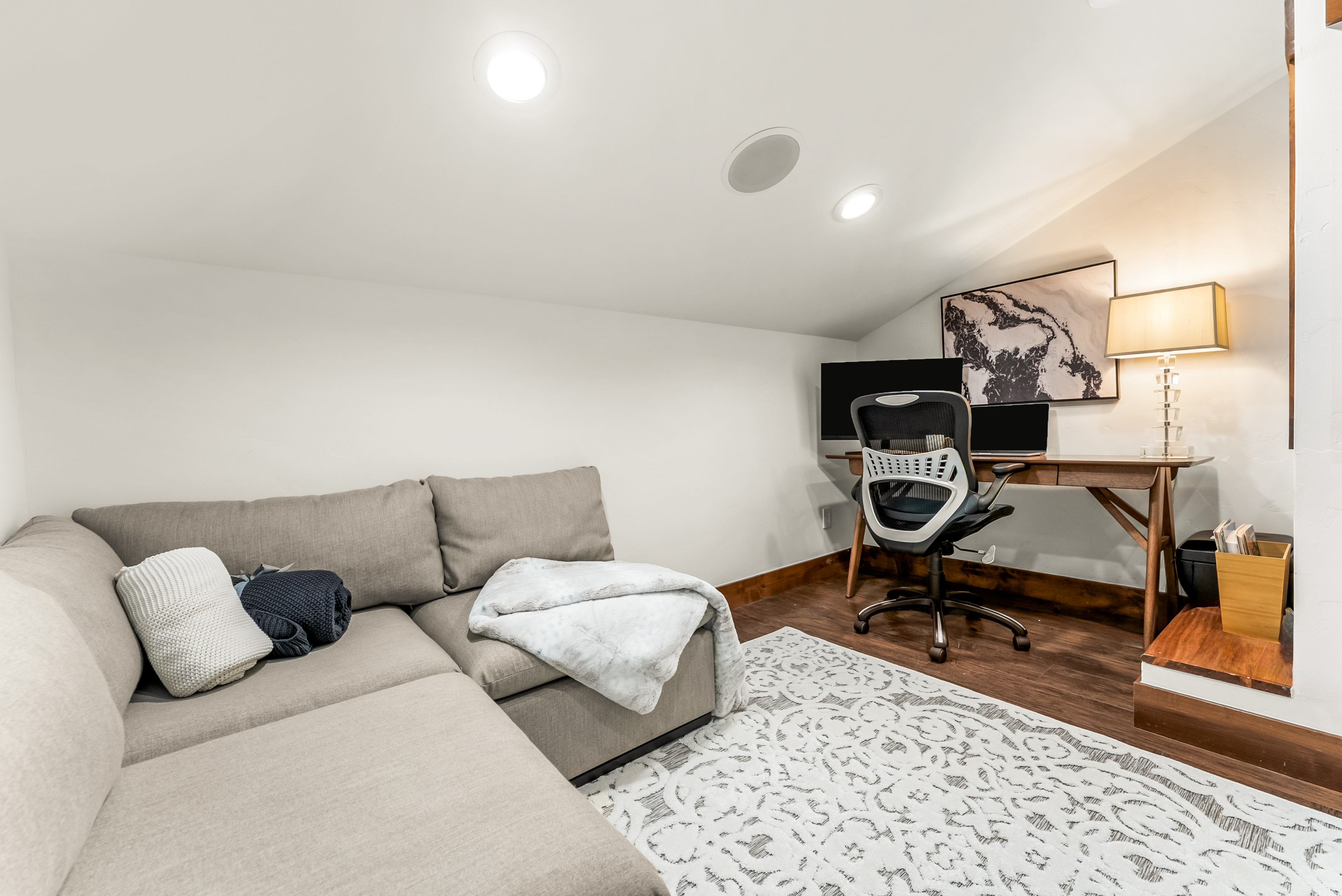 Dedicated workspace, smart TV with HDMI cable, printer, and sleeper sofa