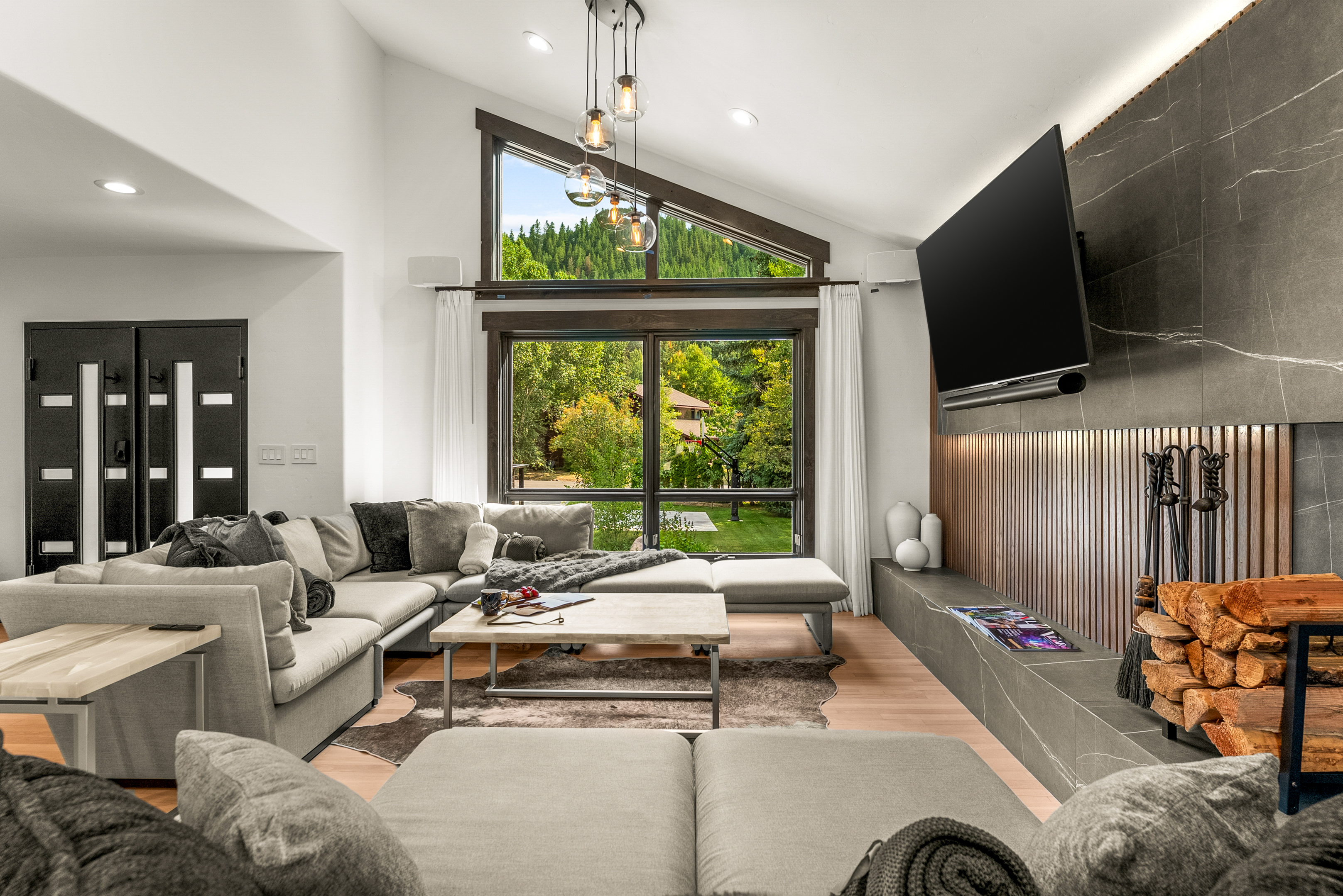 Living room: Wood-burning fireplace, smart TV, Sonos sound system, piano, main floor