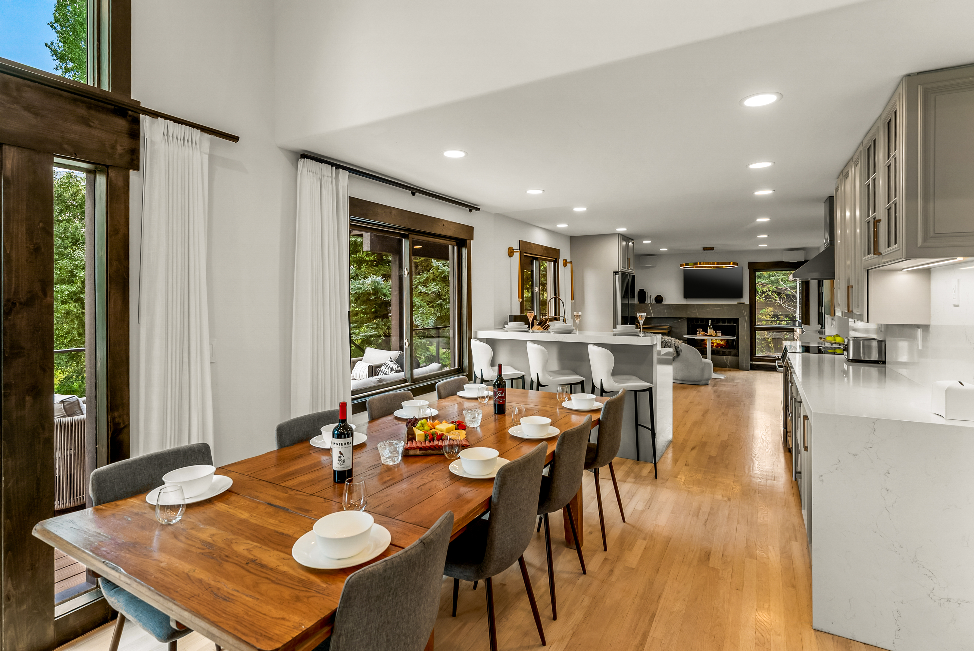 Main floor dining area: 10-seat dining table, 3 barstools