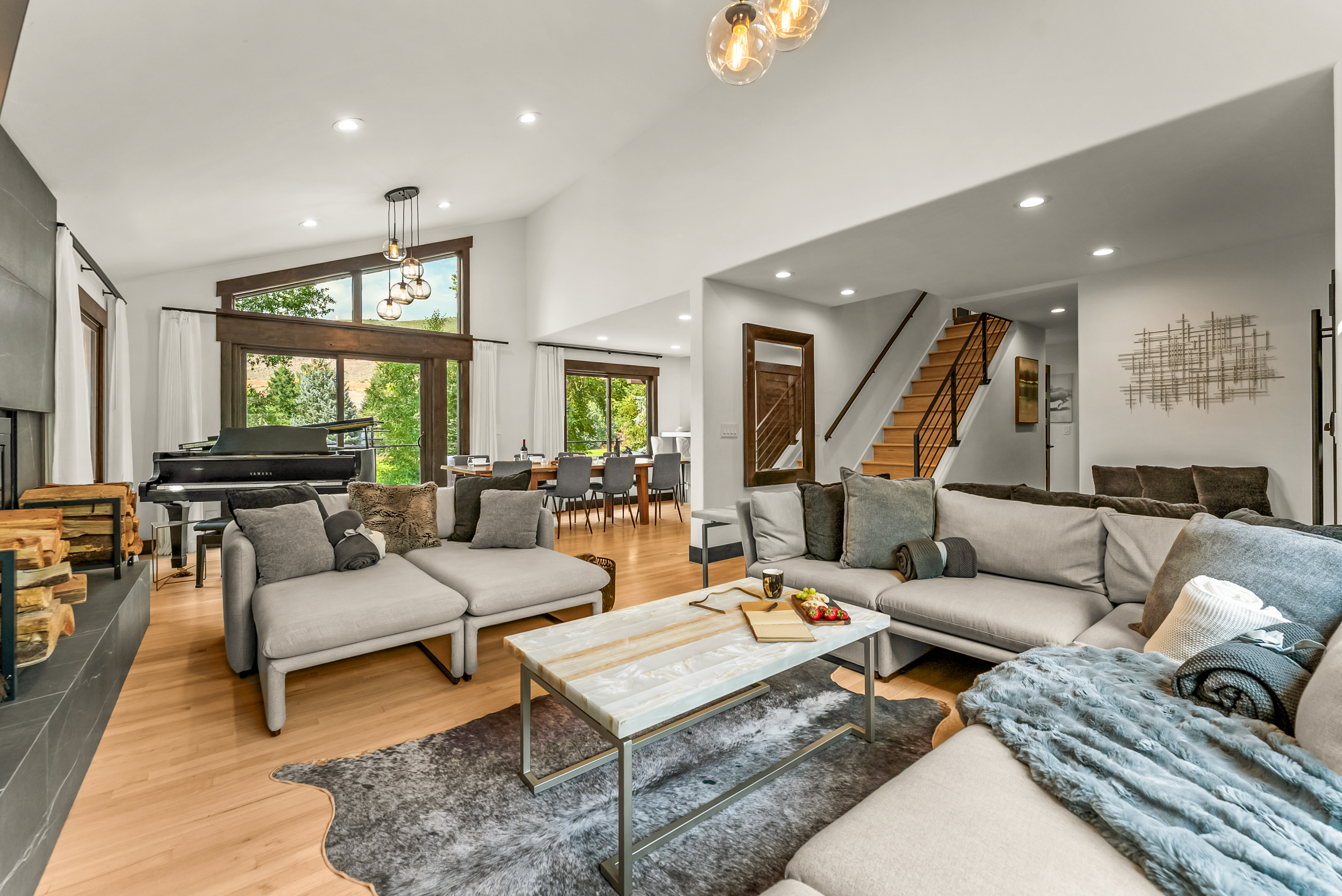Living room: Wood-burning fireplace, smart TV, Sonos sound system, piano, main floor