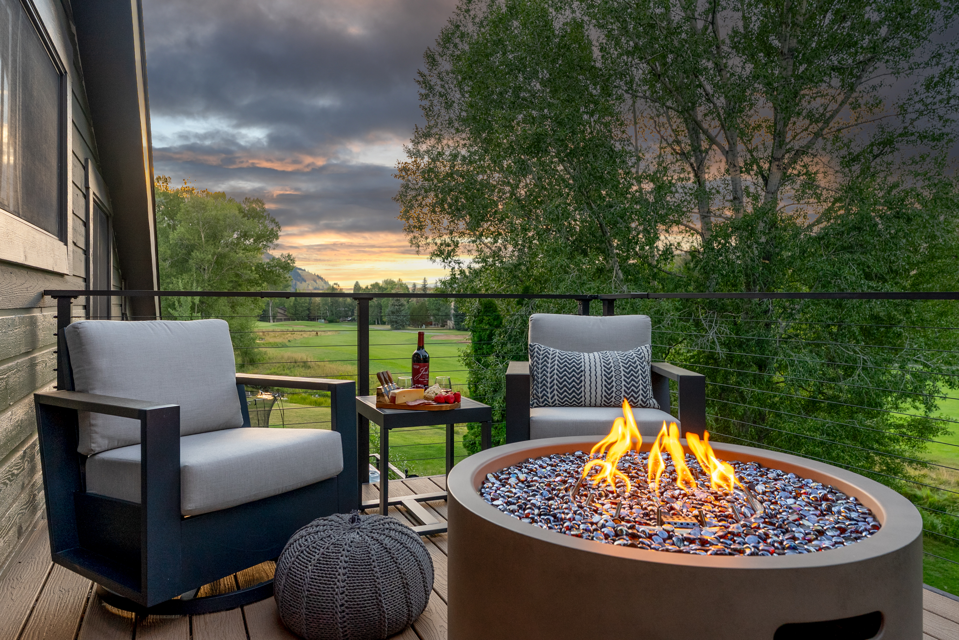 Primary bedroom balcony: Propane outdoor fire pit, seating, mountain views, upper floor