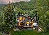 Ariel view of the home including multiple decks, 2 outdoor fire pits, an 8-person hot tub, backyard and creekside views