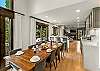 Main floor dining area: 10-seat dining table, 3 barstools