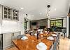 Main floor dining area: 10-seat dining table, 3 barstools