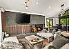 Living room: Wood-burning fireplace, smart TV, Sonos sound system, piano, main floor