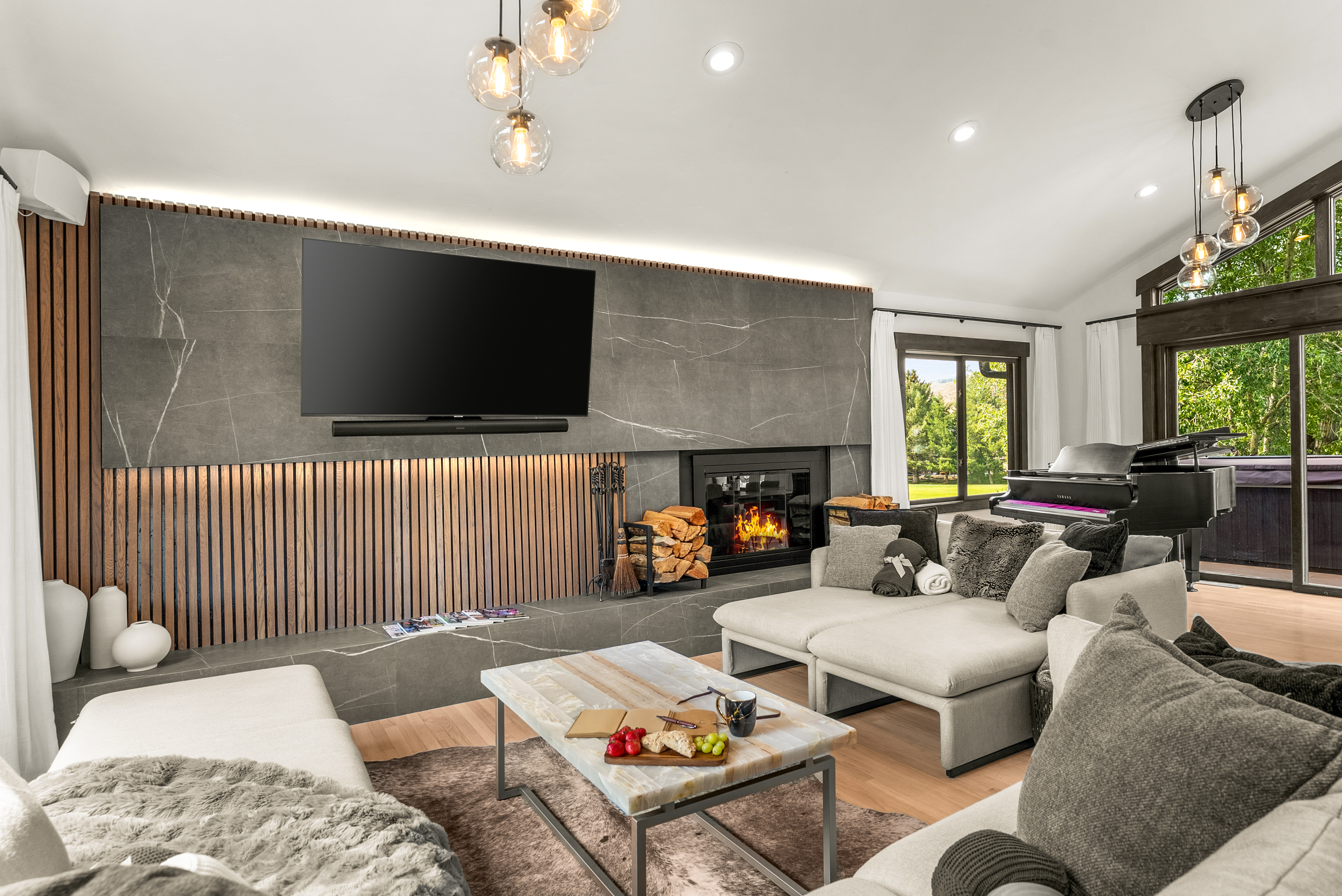 Living room: Wood-burning fireplace, smart TV, Sonos sound system, piano, main floor