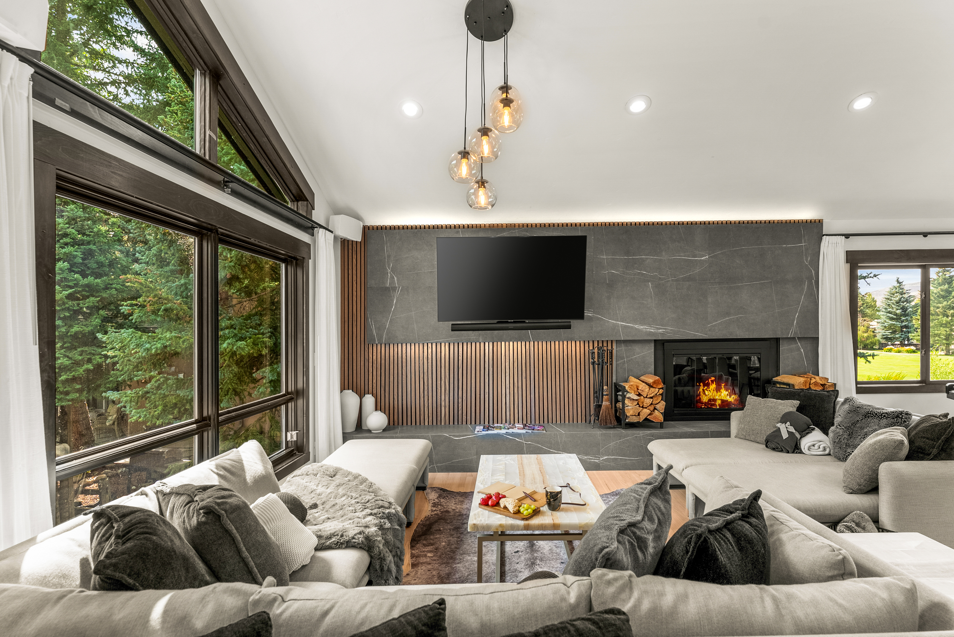 Living room: Wood-burning fireplace, smart TV, Sonos sound system, piano, main floor