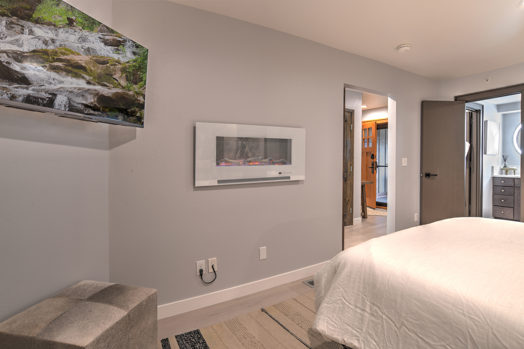 Relax and recharge in this cozy queen bedroom retreat – includes electric fireplace and Smart TV. 