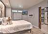 Relax and recharge in this cozy queen bedroom retreat – includes electric fireplace and Smart TV. 