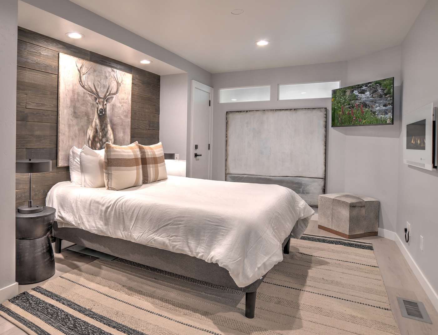 Relax and recharge in this cozy queen bedroom retreat – includes electric fireplace and Smart TV. 