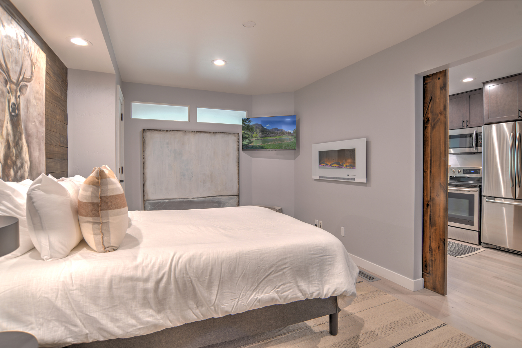 Relax and recharge in this cozy queen bedroom retreat – includes electric fireplace and Smart TV. 
