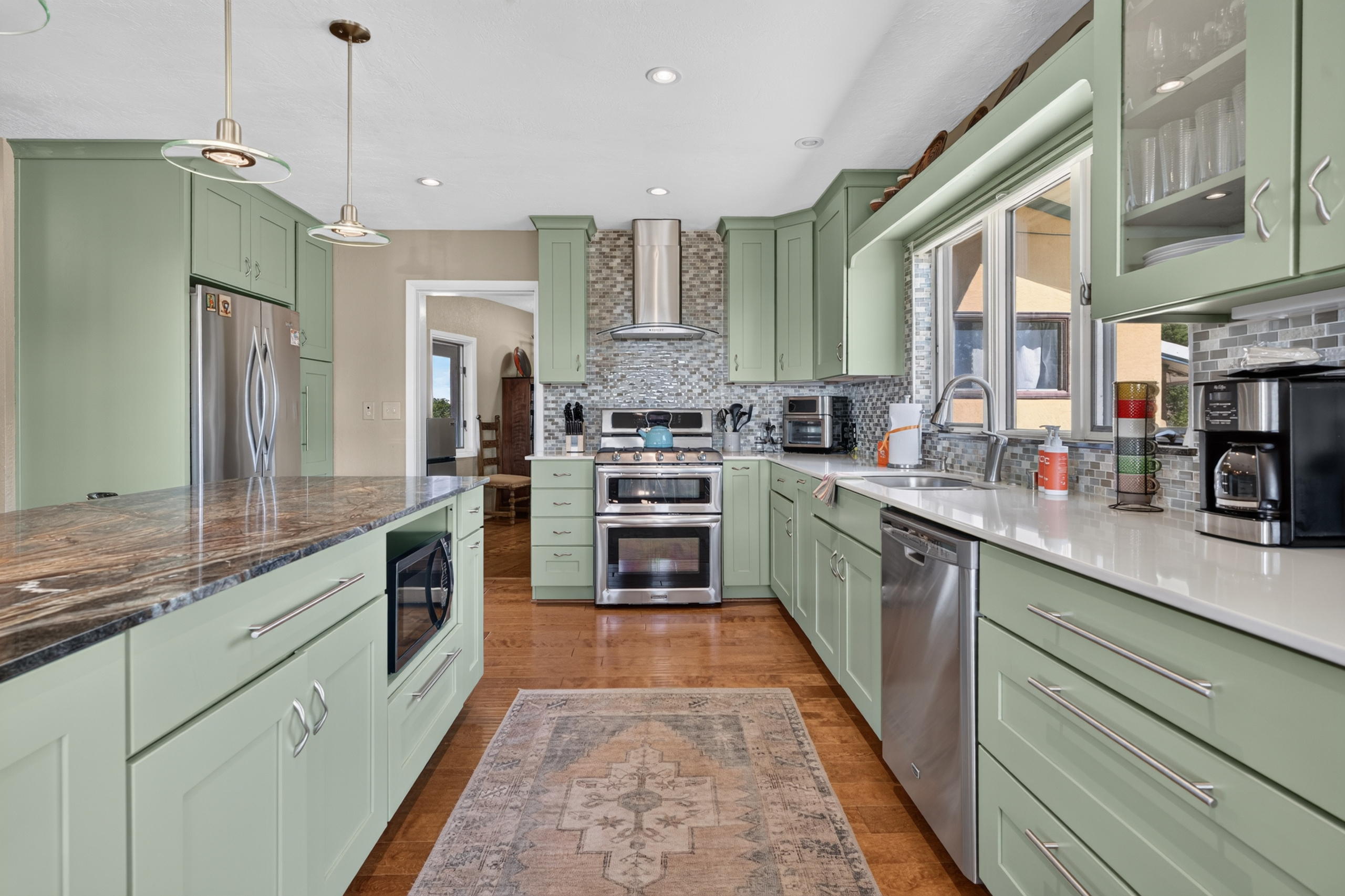 Gourmet kitchen with stainless steel appliances and breakfast bar.