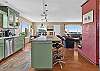Gourmet kitchen with stainless steel appliances and breakfast bar.