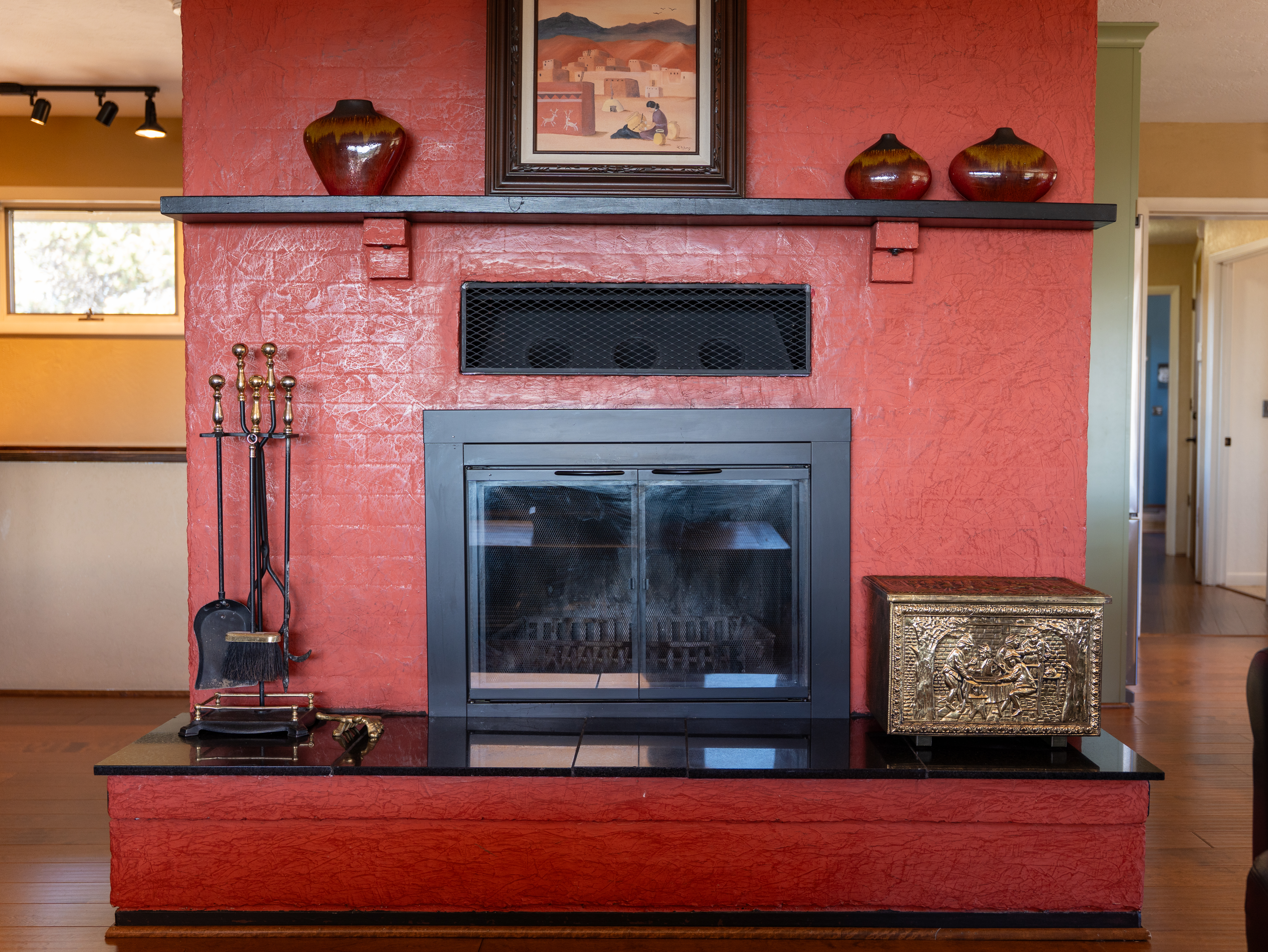 Living room with a piñon wood-burning fireplace and smartphone-ready soundbar