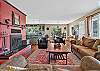 Living room with a piñon wood-burning fireplace and smartphone-ready soundbar