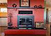 Living room with a piñon wood-burning fireplace and smartphone-ready soundbar