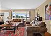 Living room with a piñon wood-burning fireplace and smartphone-ready soundbar