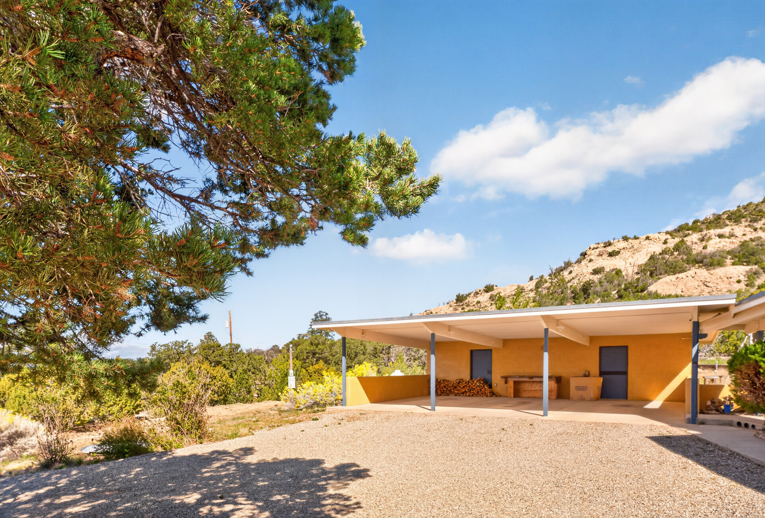 Three-car carport plus a circular drive for parking.