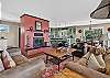 Living room with a piñon wood-burning fireplace and smartphone-ready soundbar.