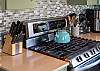 Gourmet kitchen with stainless steel appliances and breakfast bar.