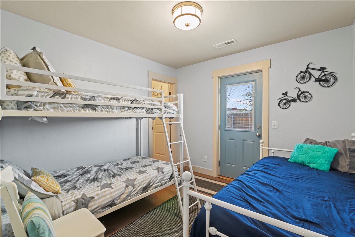 Bedroom #2 with a twin bunk bed and another twin bed.