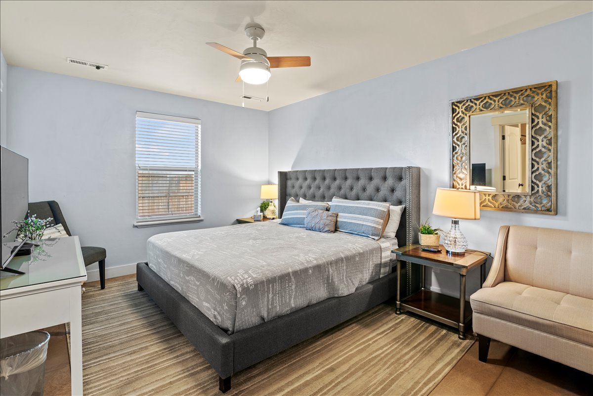 Primary bedroom with king bed and twin sofa bed. Includes a smart TV and en-suite bathroom.