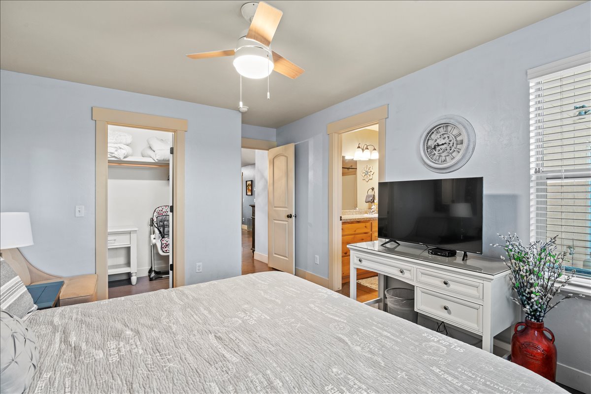 Primary bedroom with king bed and twin sofa bed. Includes a smart TV and en-suite bathroom.