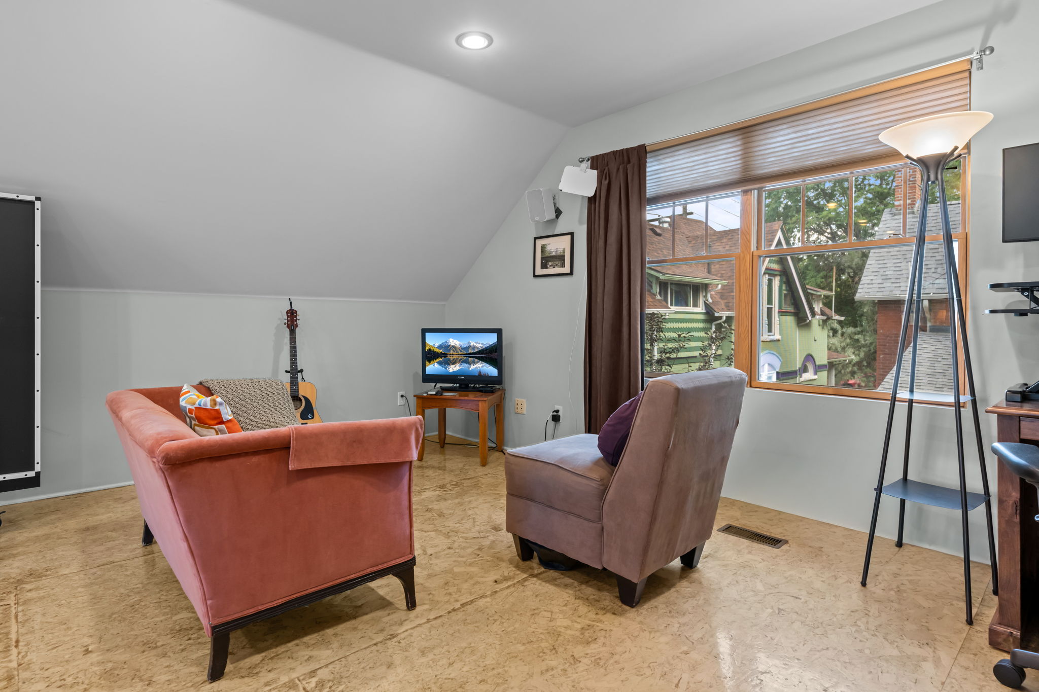 Bedroom with queen bed, living area, smart TV, and ping pong table.