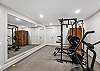Yoga and wellness room with home gym, stationary bike, and private two-person sauna.