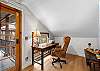 Office area equipped for remote work, with a desk and comfortable seating.