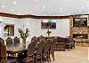 Enjoy meals together around a table that comfortably seats 14 people. 